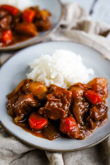 crock pot beef stew with rice on a plate