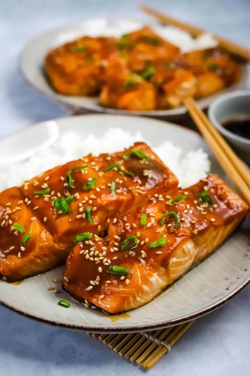 air fryer teriyaki salmon on a bed of rice on a white plate