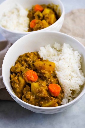 hamburger curry with rice in a white bowl