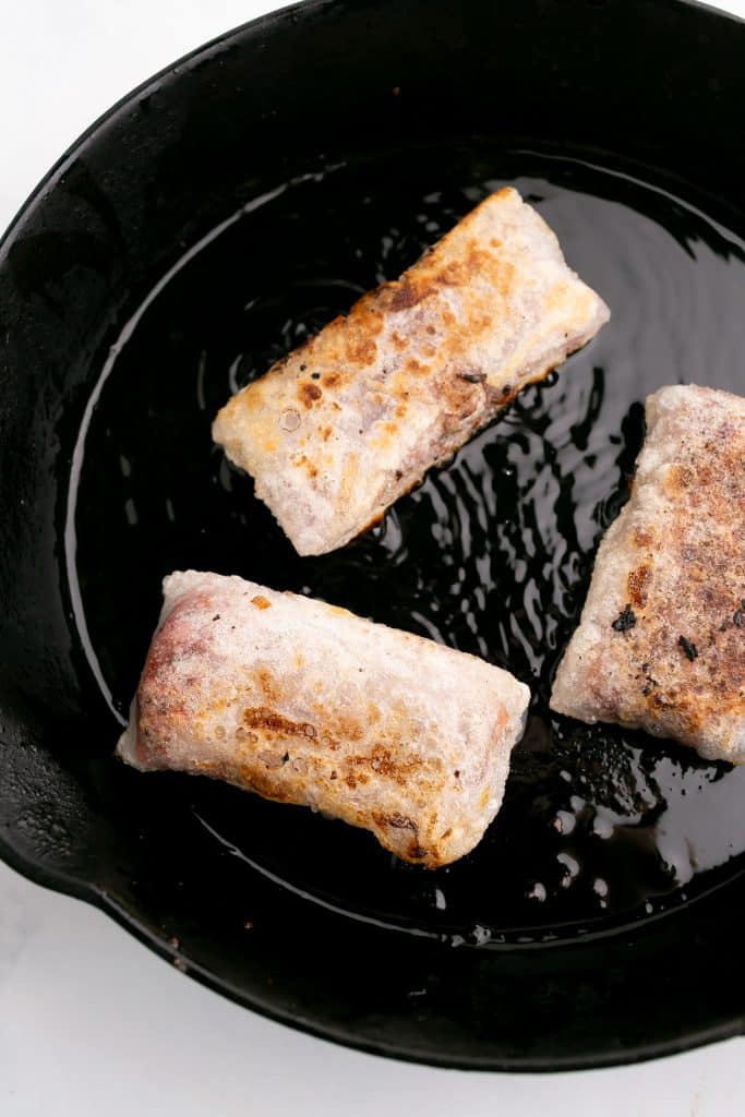 frying rice paper rolls frying in a pan