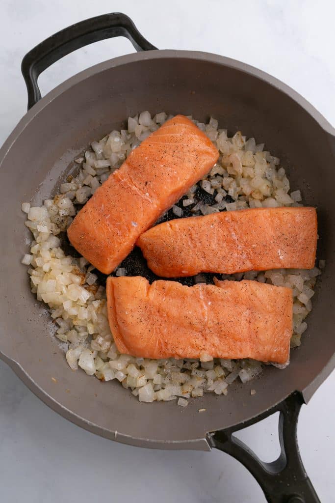 salmon cooking in a pan