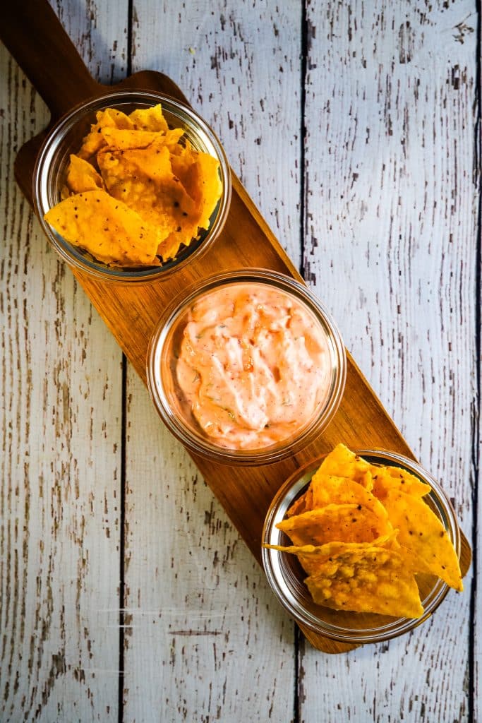 kimchi dip in a glass bowl with chips