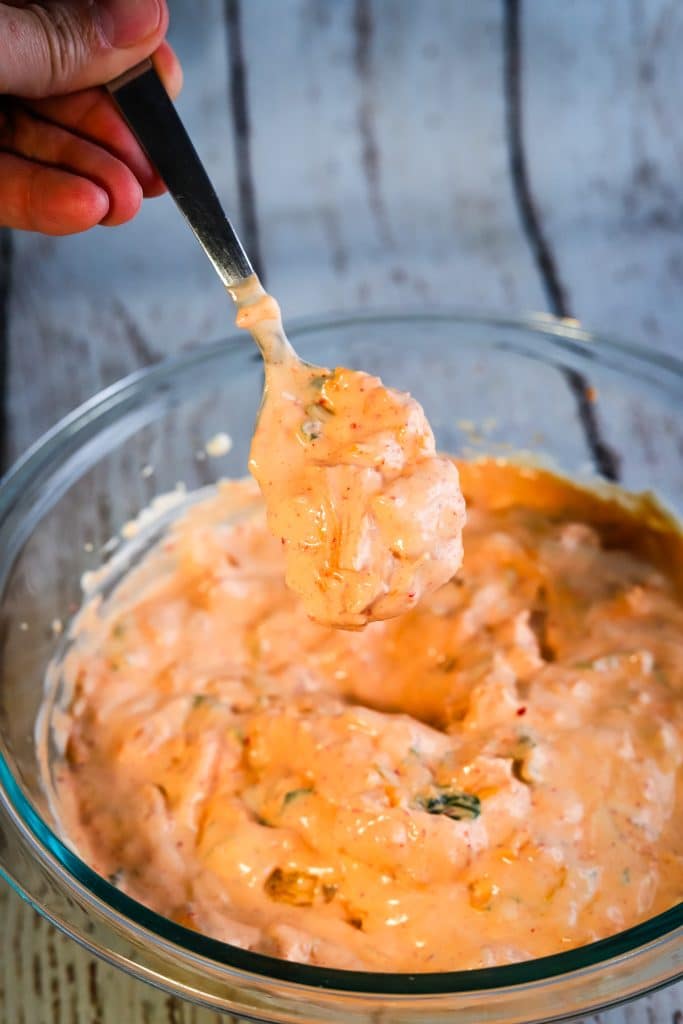 hand spooning out kimchi dip