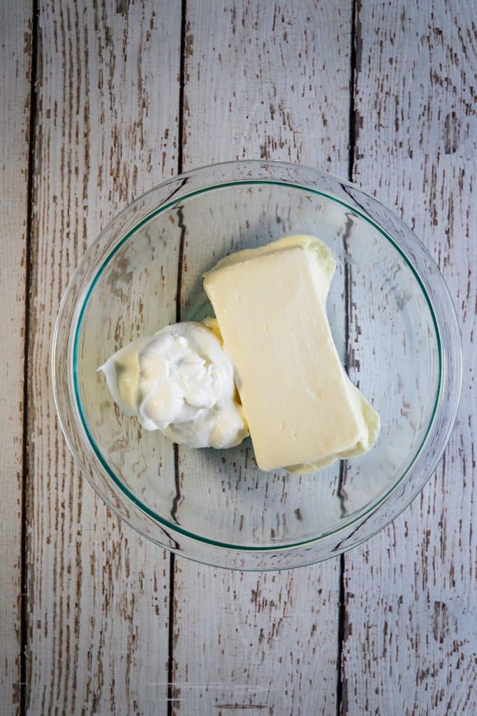 cream cheese and sour cream in a glass bowl