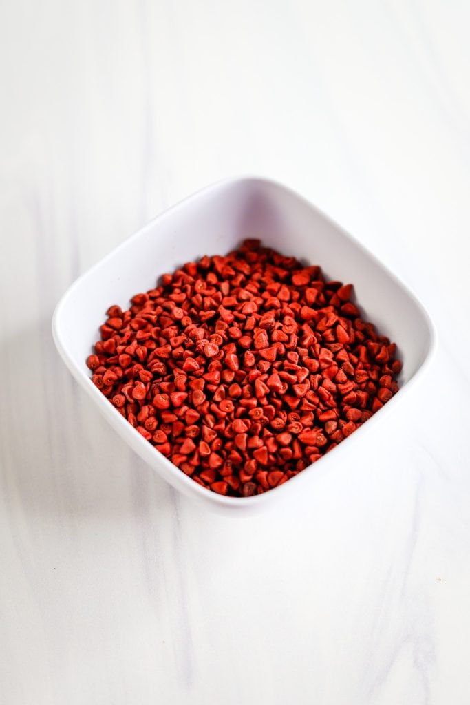 achiote seeds in a white bowl