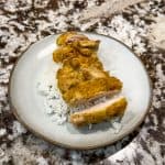 hummus chicken with rice on a plate