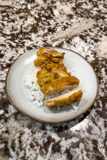 hummus chicken with rice on a plate